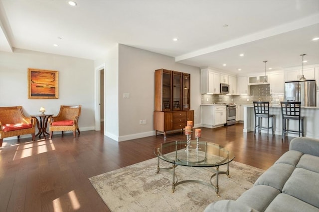 living room with dark wood finished floors, recessed lighting, and baseboards