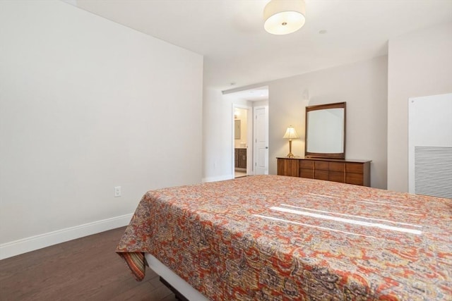 bedroom with baseboards and wood finished floors