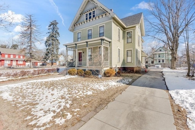 view of snowy exterior featuring a porch