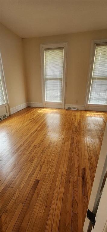 unfurnished room with light hardwood / wood-style flooring