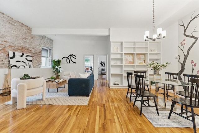 69 Harvey St Unit 1, Cambridge, MA 02140 - dining space with wood finished floors, a chandelier, brick wall, beamed ceiling, and a baseboard radiator