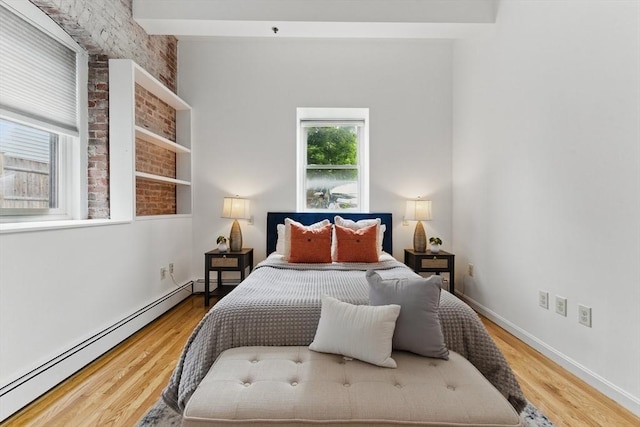 69 Harvey St Unit 1, Cambridge, MA 02140 - bedroom with a baseboard radiator, wood finished floors, and baseboards