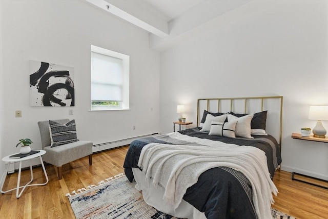 69 Harvey St Unit 1, Cambridge, MA 02140 - bedroom featuring a baseboard heating unit, wood finished floors, and beam ceiling