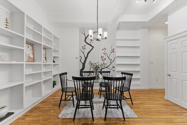 69 Harvey St Unit 1, Cambridge, MA 02140 - dining space featuring light wood-type flooring, a chandelier, and baseboards