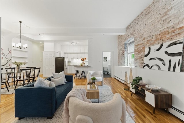 69 Harvey St Unit 1, Cambridge, MA 02140 - living area with a baseboard heating unit, a chandelier, and light wood-type flooring