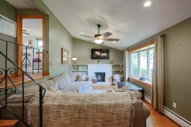 68 Partridge Dr, Brockton, MA 02301 - living room featuring ceiling fan, a baseboard heating unit, wood finished floors, a fireplace, and vaulted ceiling