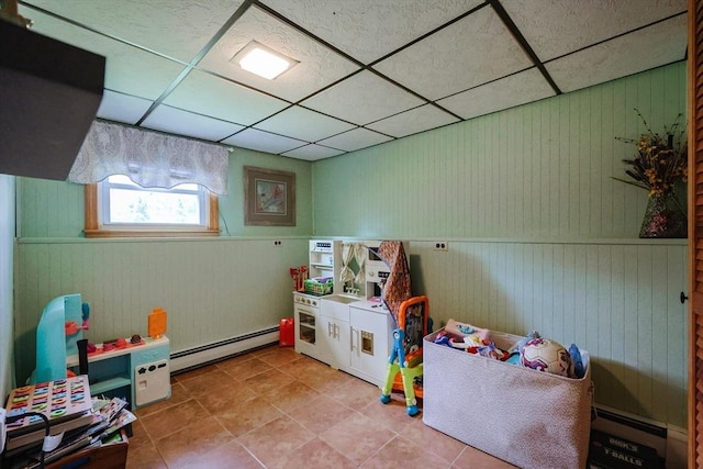 68 Partridge Dr, Brockton, MA 02301 - rec room featuring baseboard heating, a paneled ceiling, tile patterned floors, wood walls, and a wainscoted wall