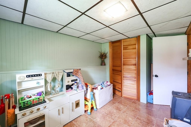 68 Partridge Dr, Brockton, MA 02301 - rec room with a drop ceiling, light tile patterned flooring, wood walls, and wainscoting
