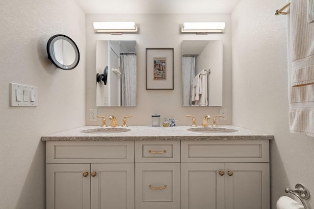 bathroom with double vanity and a sink