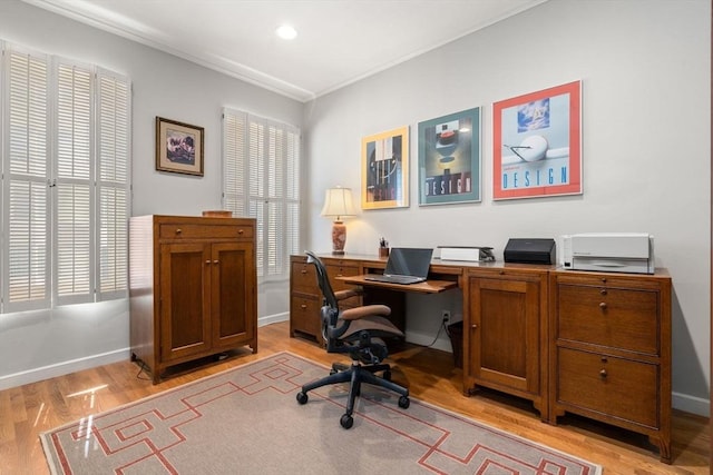 home office with baseboards, ornamental molding, and light wood-style flooring