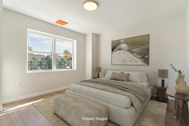 bedroom with hardwood / wood-style flooring