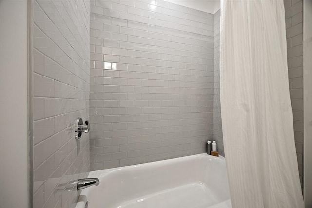 bathroom with shower / bath combination with curtain