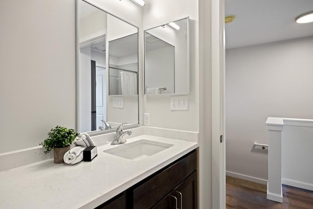 bathroom with vanity, curtained shower, and wood-type flooring