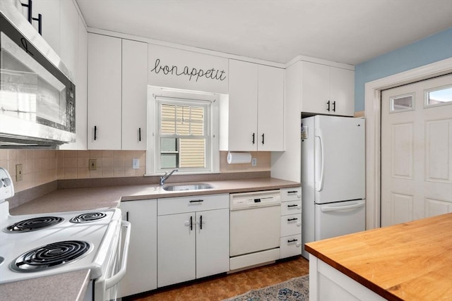 kitchen featuring butcher block counters, sink, white appliances, and white cabinets