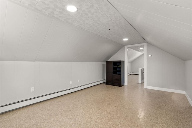 additional living space with lofted ceiling and baseboard heating