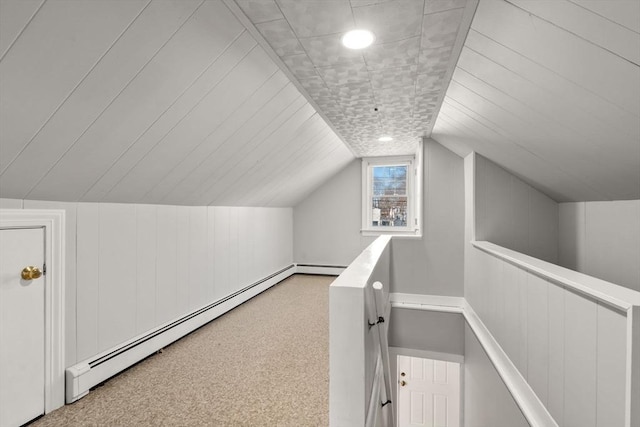 bonus room featuring carpet floors, vaulted ceiling, and a baseboard heating unit