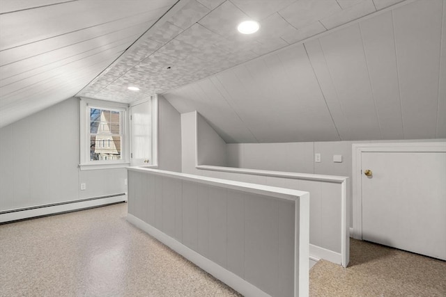 bonus room featuring vaulted ceiling and a baseboard radiator