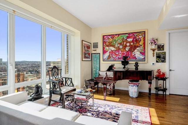 living room featuring baseboards, visible vents, and wood finished floors