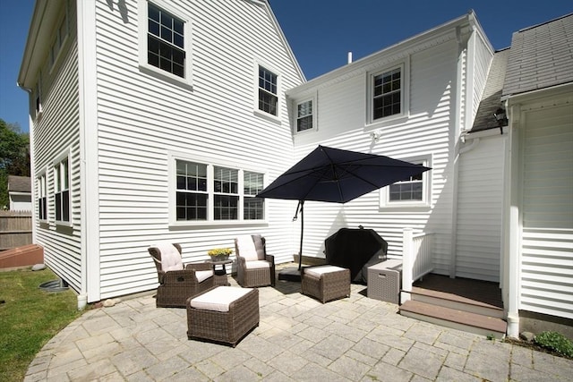 rear view of house with outdoor lounge area and a patio area