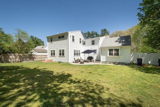 rear view of property featuring a yard, an outdoor living space, a fenced backyard, and a patio area