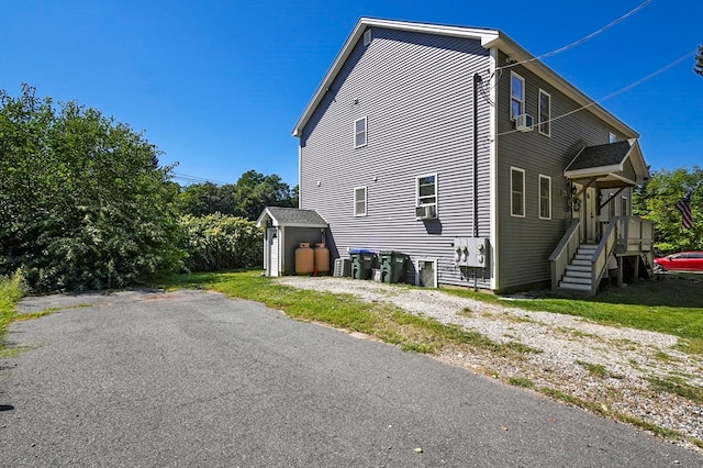 view of property exterior featuring a storage unit