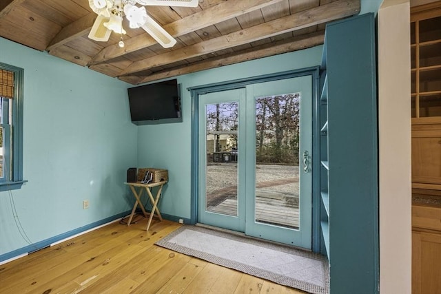 doorway featuring ceiling fan, beam ceiling, wood-type flooring, and wood ceiling