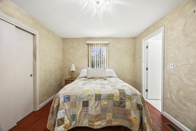 bedroom featuring a closet and dark hardwood / wood-style flooring