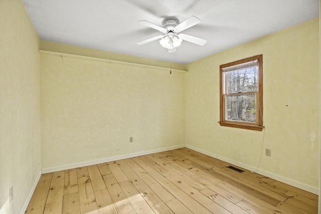 unfurnished room featuring ceiling fan and light wood-type flooring