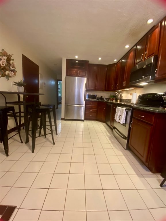 kitchen featuring stainless steel appliances and light tile patterned floors