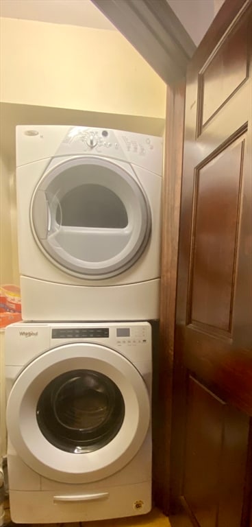 laundry area with stacked washing maching and dryer