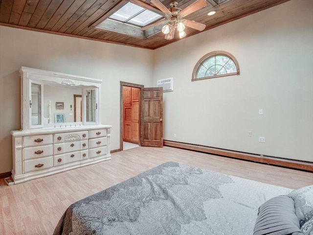 bedroom with wood ceiling, light wood-type flooring, ceiling fan, a skylight, and ornamental molding