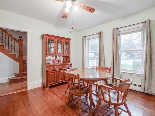 dining space featuring hardwood / wood-style flooring, ceiling fan, and a wealth of natural light