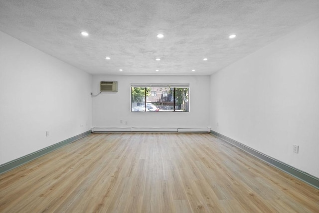 84 Grant St Unit 7, Somerville, MA 02145 - unfurnished room with wood finished floors, a wall unit AC, recessed lighting, and a baseboard radiator