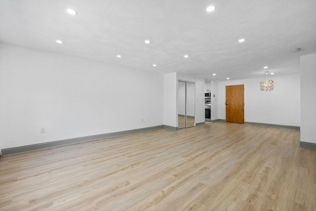 84 Grant St Unit 7, Somerville, MA 02145 - unfurnished living room with recessed lighting and light wood-type flooring