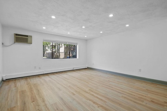 84 Grant St Unit 7, Somerville, MA 02145 - unfurnished room with a baseboard heating unit, a wall unit AC, wood finished floors, and recessed lighting
