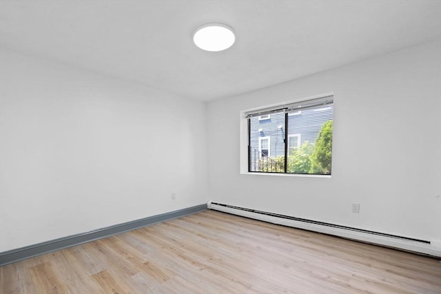 84 Grant St Unit 7, Somerville, MA 02145 - spare room with a baseboard heating unit and wood finished floors