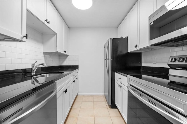84 Grant St Unit 7, Somerville, MA 02145 - kitchen featuring stainless steel appliances, dark countertops, white cabinets, and backsplash