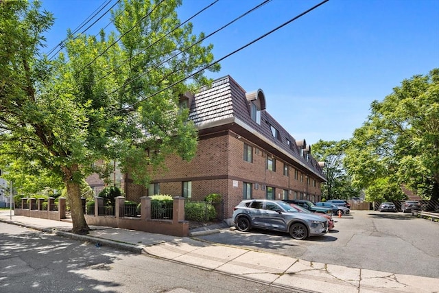 84 Grant St Unit 7, Somerville, MA 02145 - view of property featuring a fenced front yard and uncovered parking