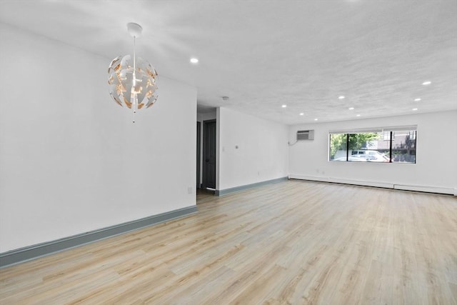 84 Grant St Unit 7, Somerville, MA 02145 - empty room featuring baseboard heating, recessed lighting, light wood-type flooring, a wall unit AC, and a chandelier