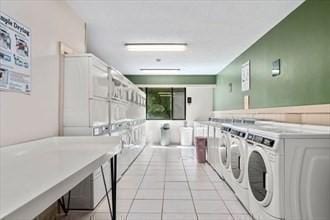 1500 Worcester Rd Unit 631, Framingham, MA 01702 - shared laundry featuring stacked washing machine and dryer, independent washer and dryer, and light tile patterned floors
