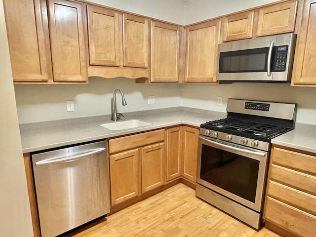 1500 Worcester Rd Unit 631, Framingham, MA 01702 - kitchen featuring stainless steel appliances, light wood-style flooring, and light countertops