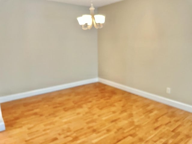 1500 Worcester Rd Unit 631, Framingham, MA 01702 - unfurnished room featuring a chandelier and wood finished floors