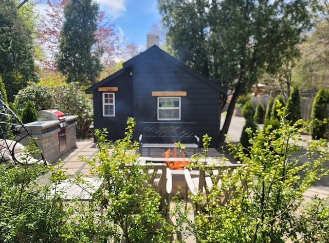 31-33 Mathews Dr, Wayland, MA 01778 - back of house with a chimney, an outdoor kitchen, and a wooden deck