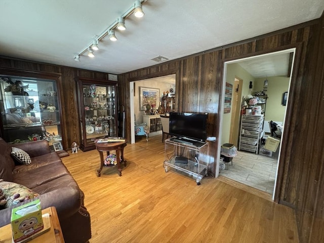 23 Harvard Cir, Needham, MA 02494 - living area featuring wooden walls, track lighting, and light wood-type flooring