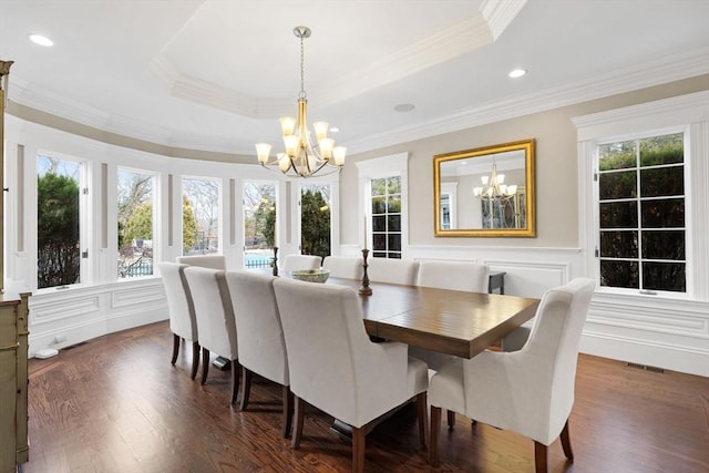 dining room featuring a tray ceiling, a notable chandelier, visible vents, and a wealth of natural light