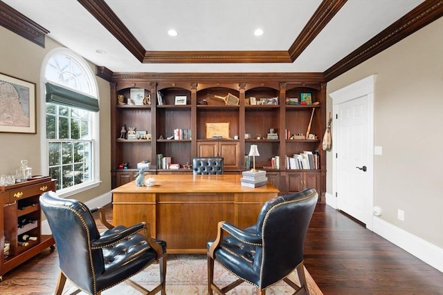 home office with a wealth of natural light, dark wood-style floors, a tray ceiling, and ornamental molding