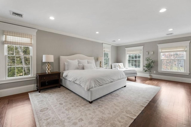 bedroom with baseboards, visible vents, and ornamental molding