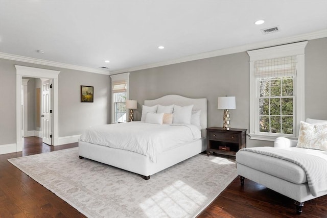 bedroom with visible vents, multiple windows, baseboards, and wood finished floors