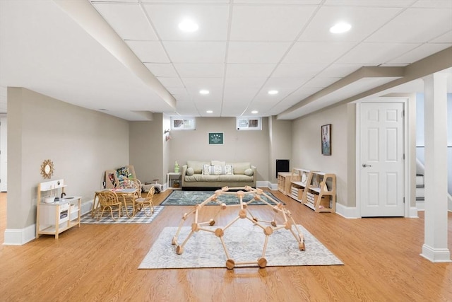 living area with recessed lighting, baseboards, and wood finished floors