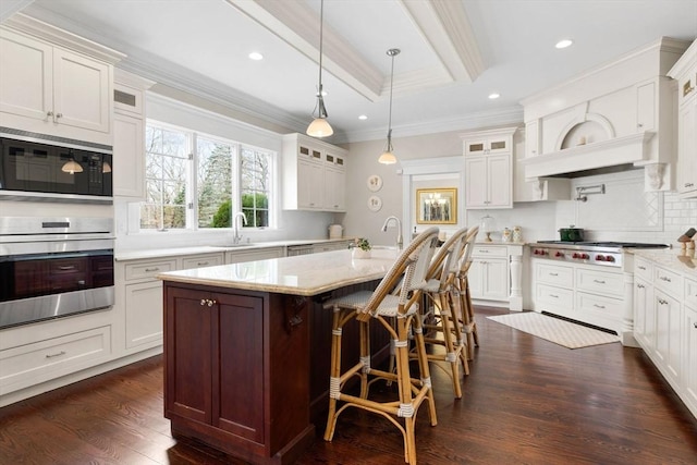 kitchen featuring dark wood finished floors, glass insert cabinets, appliances with stainless steel finishes, and ornamental molding